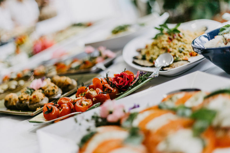 Appetizers on plates at a buffet.