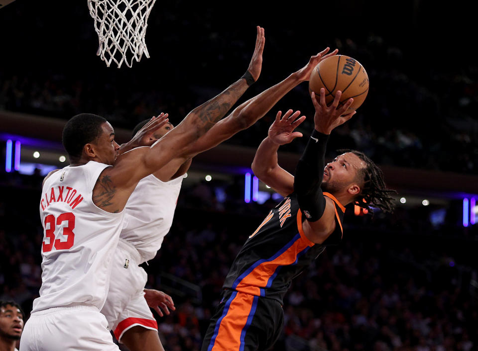 NEW YORK, NEW YORK - MARCH 01: Jalen Brunson #11 of the New York Knicks heads for the net as Nic Claxton #33 anfd Mikal Bridges #1 of the Brooklyn Nets defend in the second half at Madison Square Garden on March 01, 2023 in New York City. The New York Knicks defeated the Brooklyn Nets 149-118. NOTE TO USER: User expressly acknowledges and agrees that, by downloading and or using this photograph, User is consenting to the terms and conditions of the Getty Images License Agreement. (Photo by Elsa/Getty Images)