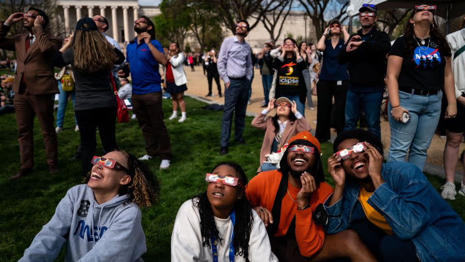 People gather on the National Mall to view the solar eclipse on April 8, 2024, in Washington, DC. - Kent Nishimura/Getty Images