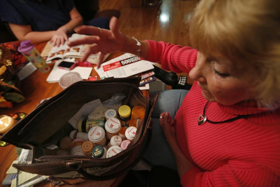 REFILE - ADDING REFERENCE TO ACCOUNTABLE CARE ORGANIZATIONS Sandy Wright looks over her bag of medications at her home in Peoria, Illinois, November 25, 2013. Wright has Neuromyelitis Optica and has a Certified Nursing Assistant come to help her around the house. Now, patients like Wright are at the forefront of an experiment, under way in Peoria, Illinois, and hundreds of other U.S. cities, that could transform the way doctors, nurses and hospitals deliver care to patients. Amid the barrage of criticism over the rollout of Obamacare, groups known as Accountable Care Organizations (ACOs) are quietly going about the business of testing the potential for healthcare reform. The efforts, born of President Barack Obama's Affordable Care Act, are part of the biggest experiment yet to fix the costly and error-plagued U.S. healthcare system. The new models of care, which encourage providers to form networks to coordinate care and cut costs, involve close monitoring of the sickest patients to address budding health problems before they cause a costly trip to the emergency room or an extended hospital stay. To match Feature USA-HEALTHCARE/PEORIA Picture taken November 25, 2013. REUTERS/Jim Young (UNITED STATES - Tags: HEALTH POLITICS)