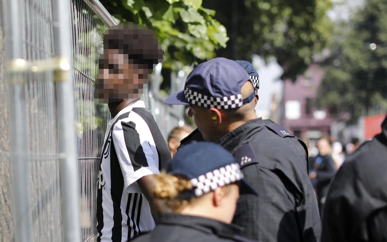 Police stop and search a man at Notting Hill Carnival in 2017 - GETTY IMAGES