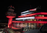 The Tegel Airport is illuminated in red Saturday, Nov. 7, 2020, in Berlin, Germany. The ceremonial last flight is scheduled for Sunday. (Fabian Sommer/dpa via AP)