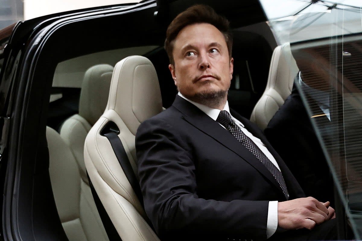 Tesla Chief Executive Officer Elon Musk gets in a Tesla car as he leaves a hotel in Beijing (REUTERS)