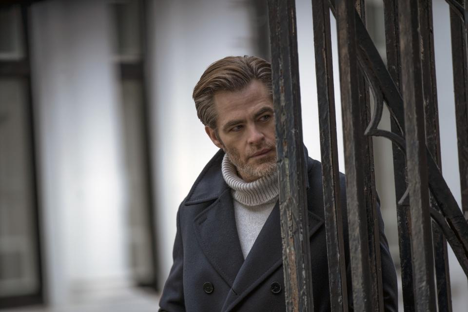 Chris Pine looks out from behind a gate