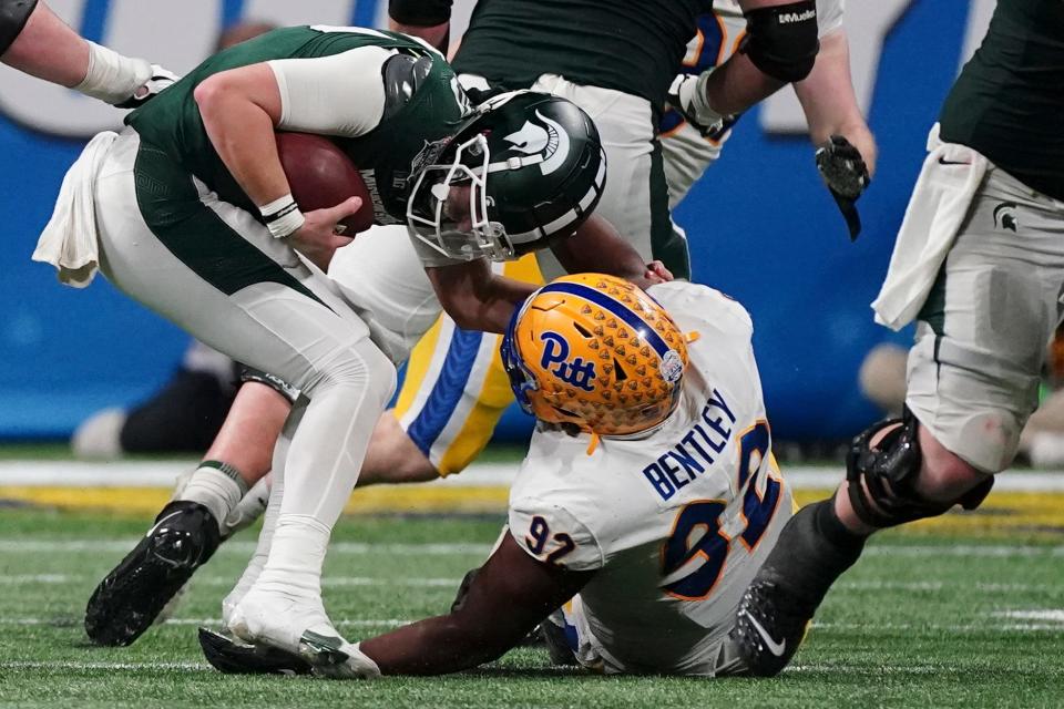 Pittsburgh defensive lineman Tyler Bentley (92) sacks Michigan State quarterback Payton Thorne (10) during the first half of the Peach Bowl NCAA college football game, Thursday, Dec. 30, 2021, in Atlanta.