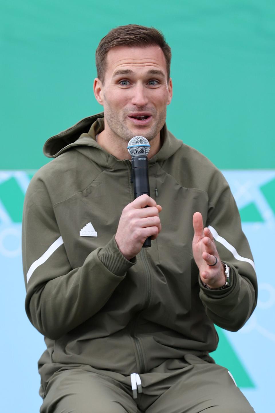 LAS VEGAS, NEVADA - FEBRUARY 09: Kirk Cousins speaks in a huddle on the field as adidas debuts its brand campaign with a star-studded roster of athletes at Resorts World Las Vegas on February 09, 2024 in Las Vegas, Nevada. (Photo by Joe Scarnici/Getty Images for adidas)