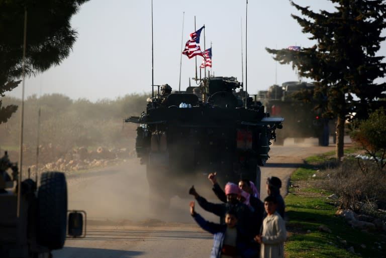 US troops are greeted by cheering crowds as they carry out a patrol in northern Syria on March 5, 2017 in support of their Kurdish-led Syrian Democratic Forces allies