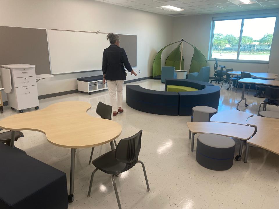 Early Childhood Center director Robin Rice tours a classroom in the new building Wednesday, pointing out the variety of seating elements each kindergarten classroom is equipped with.