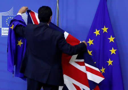 FILE PHOTO: Flags are arranged at the EU Commission headquarters ahead of a first full round of talks on Brexit, Britain's divorce terms from the European Union, in Brussels, Belgium July 17, 2017. REUTERS/Yves Herman/File Photo