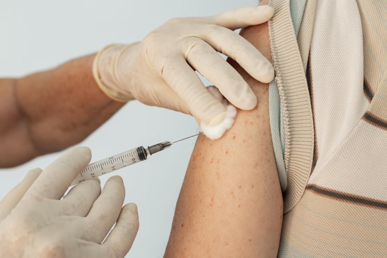 The CDC recommends getting your updated COVID-19 shot and your seasonal flu shot as soon as possible. <a href="https://www.gettyimages.com/detail/photo/closeup-on-nurse-hands-applying-vaccine-to-elderly-royalty-free-image/1295041291" rel="nofollow noopener" target="_blank" data-ylk="slk:AngelaMacario/iStock via Getty Images;elm:context_link;itc:0;sec:content-canvas" class="link ">AngelaMacario/iStock via Getty Images </a>