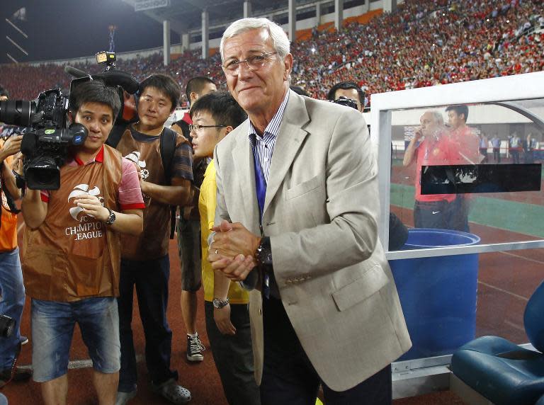 File photo of coach Marcello Lippi arriving at the Guangzhou's Tianhe stadium, to lead his new Chinese club Guangzhou Evergrande, on May 30, 2012
