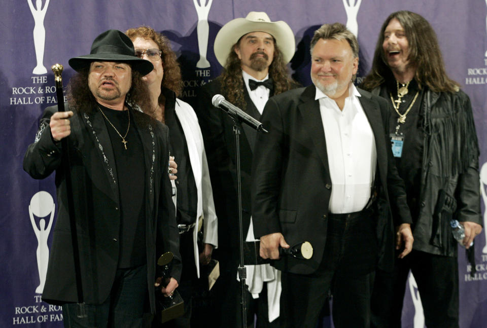 FILE - In this March 13, 2006 file photo, members of Lynyrd Skynyrd, from left, Gary Rossington, Billy Powell, Artimus Pyle, Ed King and Bob Burns, appear backstage after being inducted at the annual Rock and Roll Hall of Fame dinner in New York. A family statement said King, who helped write several of their hits including “Sweet Home Alabama,” died from cancer, Wednesday, Aug. 22, 2018, in Nashville, Tenn. He was 68. (AP Photo/Stuart Ramson, File)