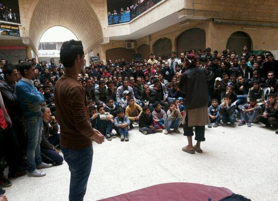FILE - In this picture released Thursday, Nov. 28, 2013, and posted on the Facebook page of a militant group, a member of the al-Qaida linked Islamic State of Iraq and the Levant (ISIL) gives a lecture at the Engineering College in the northern city of Raqqa, Syria. Syrian rebels surrounded a large compound held by al-Qaida-linked fighters and freed at least 50 people from a nearby prison Monday, Jan. 6, 2014, as clashes between the rival factions spread to the largest city under opposition control. (AP Photo, File)