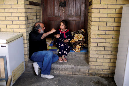 Director Hassan Husni speaks to an Iraqi girl actor to prepare for a scene of Òthe hotelÓ TV series, which is being filmed and broadcast during the Muslim holy month of Ramadan, in Baghdad, Iraq May 12, 2019. Picture taken May 12, 2019. REUTERS/Thaier al-Sudani