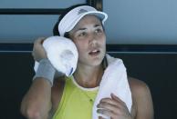 Tennis - Australian Open - Rod Laver Arena, Melbourne, Australia, January 18, 2018. Garbine Muguruza of Spain wipes her face with iced towels during a break in her match against Hsieh Su-Wei of Taiwan. REUTERS/Thomas Peter