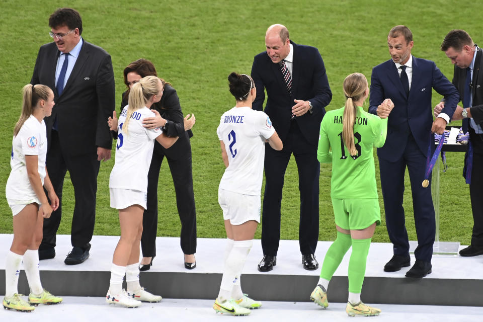 Britain's Prince William, the Duke of Cambridge, centre right, shakes hands with England's Lucy Bronze during a medal ceremony after the Women's Euro 2022 final soccer match between England and Germany at Wembley stadium in London, Sunday, July 31, 2022. England won 2-1. (AP Photo/Rui Vieira)