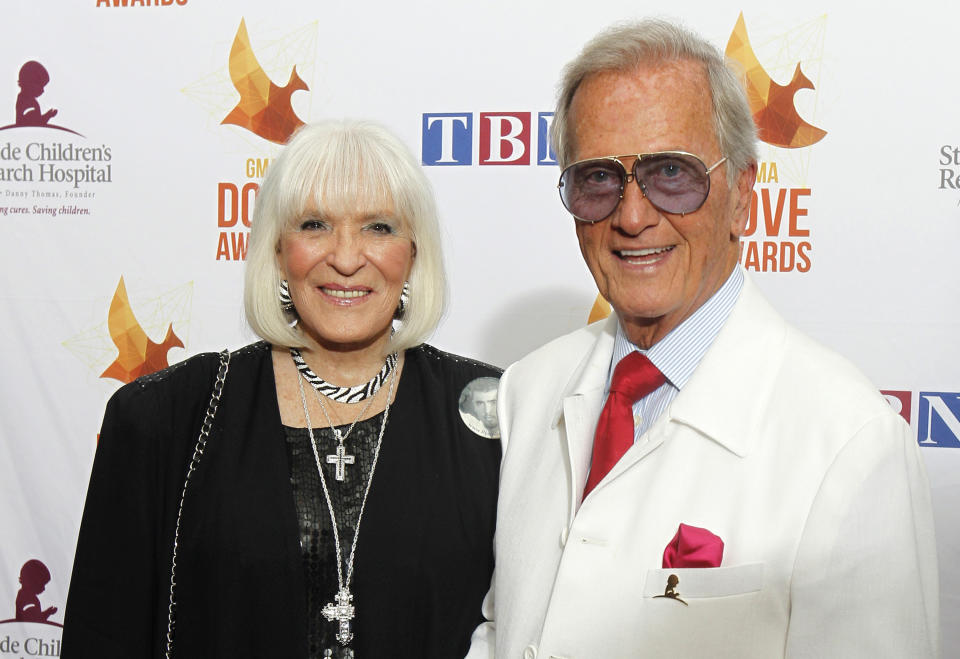 FILE - In this Oct. 7, 2014 file photo, Pat Boone, right, and wife Shirley Boone arrive at Lipscomb University for the Dove Award, in Nashville, Tenn. Shirley Boone, the longtime wife of singer Pat Boone as well as a philanthropist, has died at age 84. Milt Suchin, Pat Boone's manager, says in a statement that Shirley Boone passed away on Friday, Jan. 11, 2019, surrounded by her four daughters, who sang to her. (Photo by Wade Payne/Invision/AP, File)
