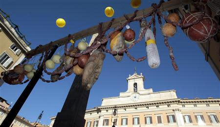 Salami is pictured hung by farmers to protest in front of the Italian parliament building in downtown Rome, December 5, 2013. REUTERS/Remo Casilli