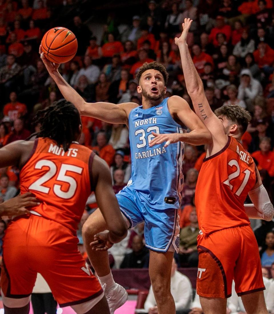 North Carolina’s Pete Nance (32) puts up a shot against Virginia Tech’s Grant Basile (21) during the second half on Sunday, December 4, 2022 at Cassell Coliseum in Blacksburg, Va. Nance scored 18 points in the Tar Heels’ loss.