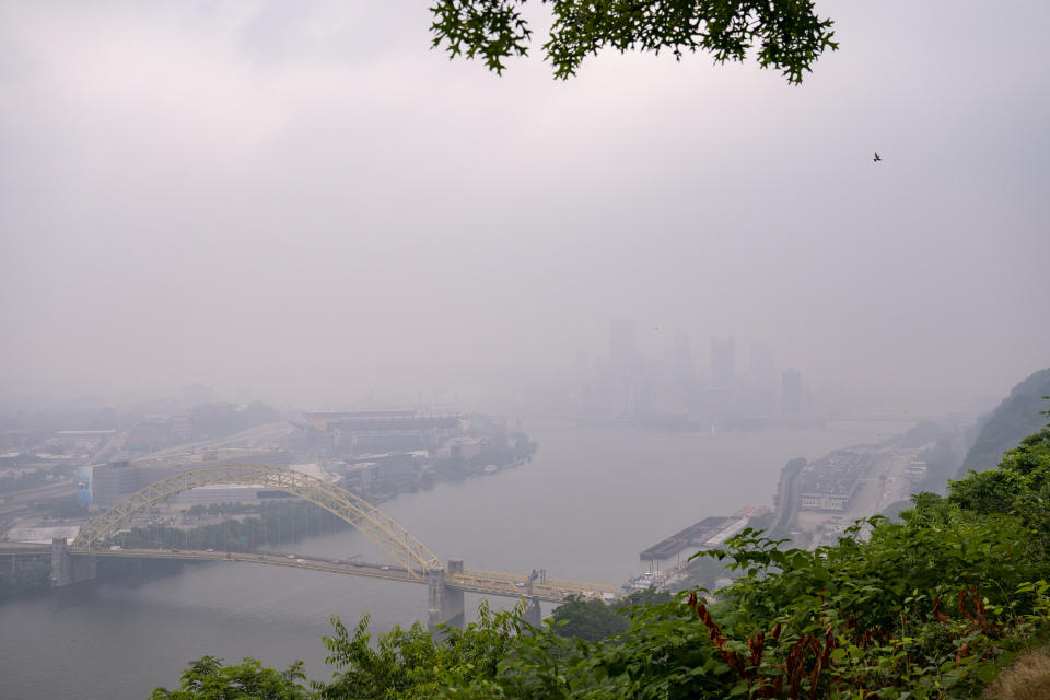 Haze from Canadian wildfires blankets the downtown Pittsburgh skyline as seen from West End Overlook in Elliott, Pa., Wednesday, June 28, 2023. (Benjamin B. Braun/Pittsburgh Post-Gazette via AP)