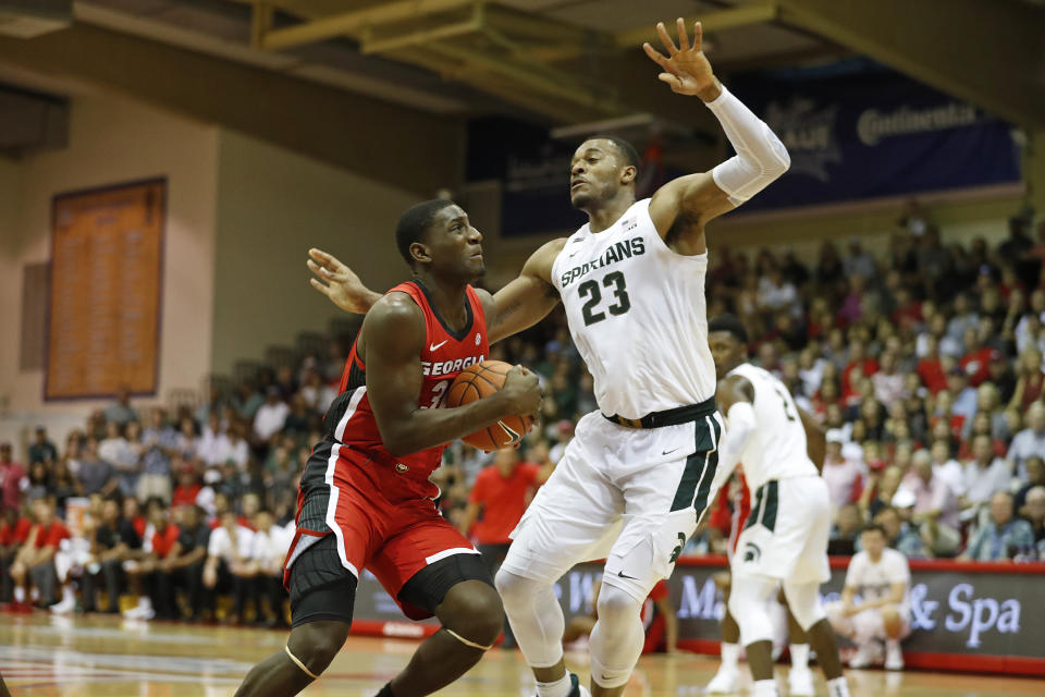 Georgia forward Mike Peake (30) tries to get to the basket over Michigan State forward Xavier Tillman (23) during the first half of an NCAA college basketball game Tuesday, Nov. 26, 2019, in Lahaina, Hawaii. (AP Photo/Marco Garcia)