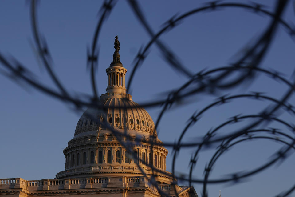 The Capitol is seen through razor wire at sunrise in Washington, Friday, March 5, 2021. (AP Photo/Carolyn Kaster)