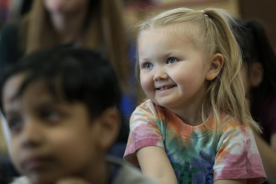 Stella Schmitzer listens to an interactive read-aloud activity during her 4K class at Foster Elementary School.