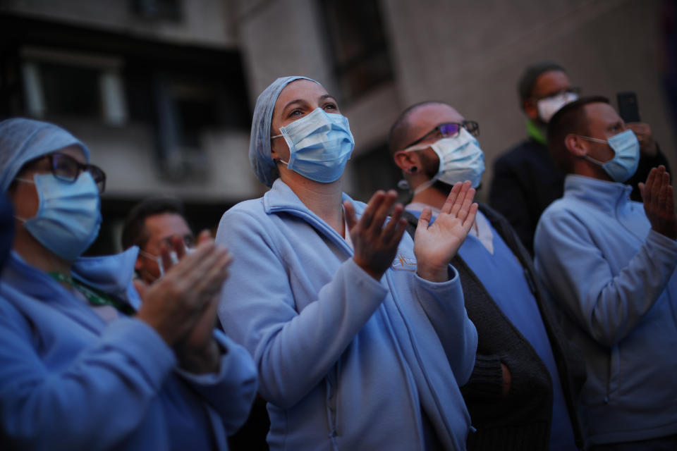 Medical personnel shout slogans during a protest outside Chirec hospital in Braine-l'Alleud, near Brussels, Belgium, Thursday, Nov. 5, 2020. COVID-19 coronavirus cases have surged around Europe in recent weeks, putting fresh pressure on overworked medical staff and hospitals, and forcing several countries to impose tough new movement restrictions. (AP Photo/Francisco Seco)