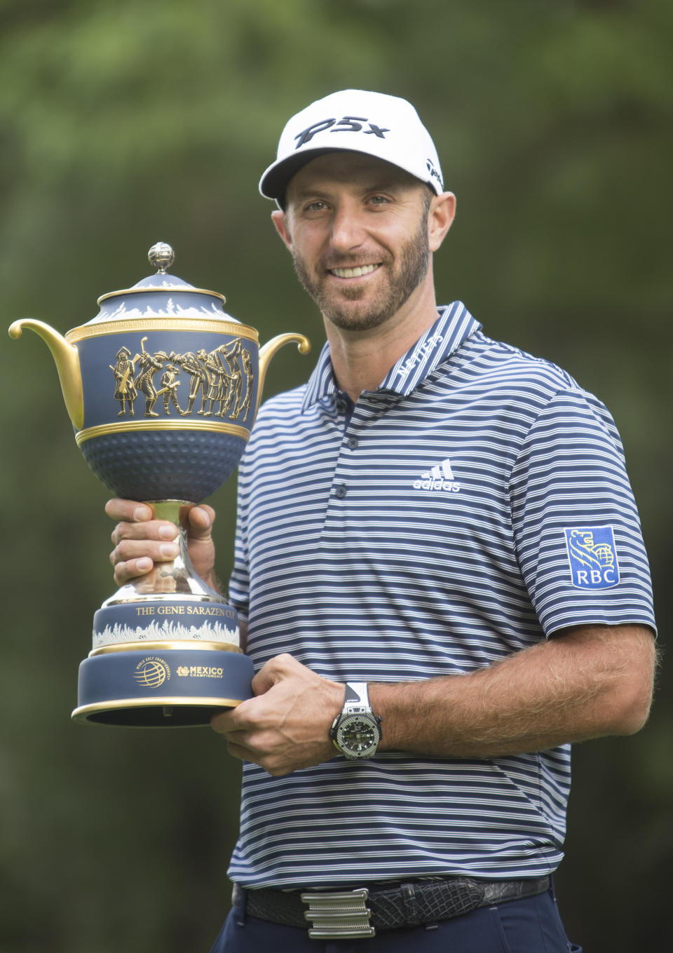 U.S. golfer Dustin Johnson poses with his Mexico Championship trophy at the Chapultepec Golf Club in Mexico City, Sunday, Feb. 24, 2019. (AP Photo/Christian Palma)