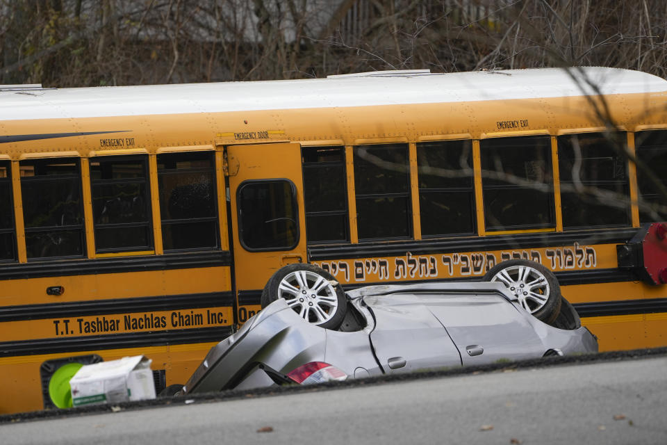 A school bus involved in an accident is seen in New Hempstead, N.Y., Thursday, Dec. 1, 2022. Multiple injuries were reported Thursday when a school bus crashed into a house and another vehicle in a suburb north of New York City. (AP Photo/Seth Wenig)