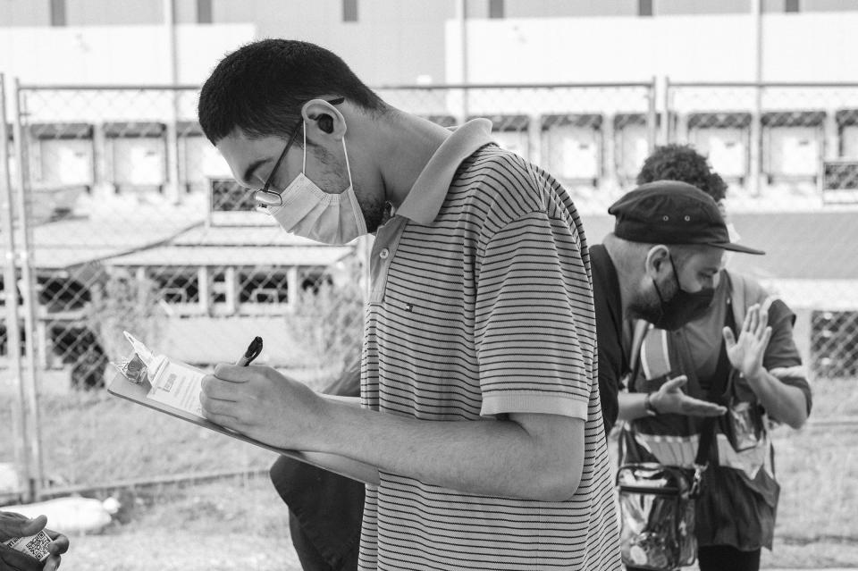 A man reviews the ALU (Amazon Labor Union) information during a drive to organize workers in June 2021.<span class="copyright">Stephen Obisanya</span>