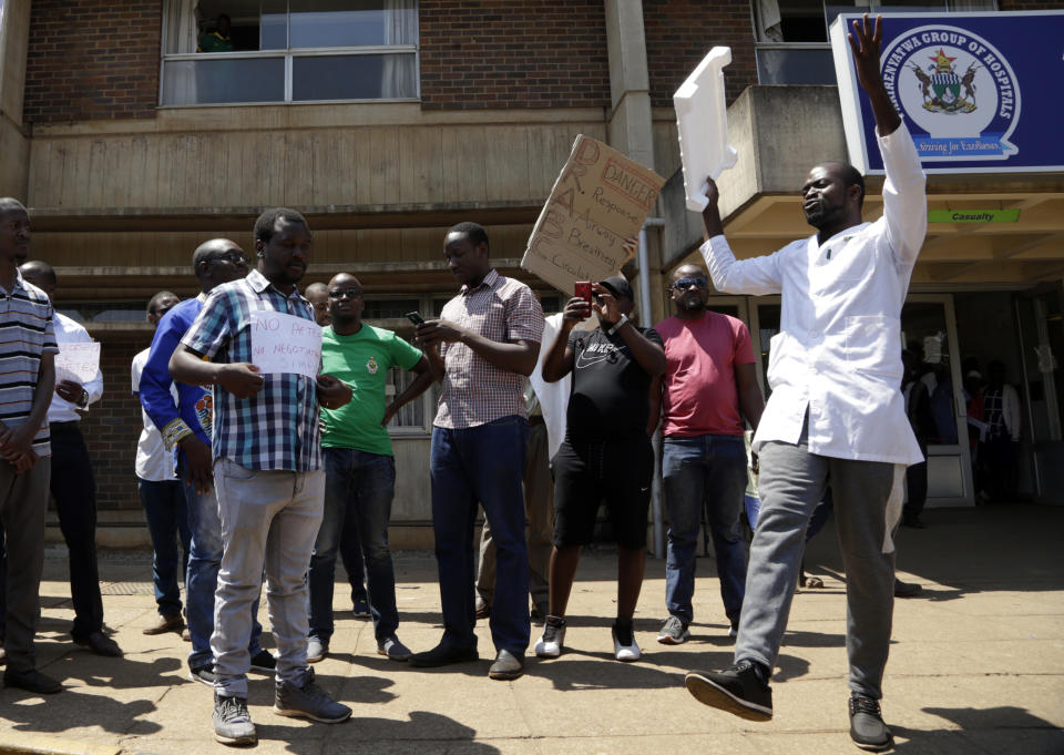 A group of Zimbabwean doctors protest at Parirenyatwa hospital in Harare, Zimbabwe, Sunday, Sept. 15, 2019. The Zimbabwe Hospital Doctors Association, which represents hundreds of junior doctors countrywide, said the association's president Peter Magombeyi was abducted on Saturday, days after receiving threats on his phone. (AP Photo/Themba Hadebe)