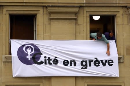 Students display a banner on the Cite secondary school a women's strike in Lausanne