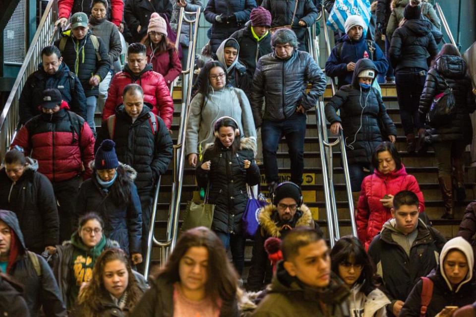 Subway passengers enter the Roosevelt Avenue station, Tuesday, December 18, 2018, in Jackson Heights, New York. It is considered one of the most diverse communities in the United States, with more than 160 languages being spoken.