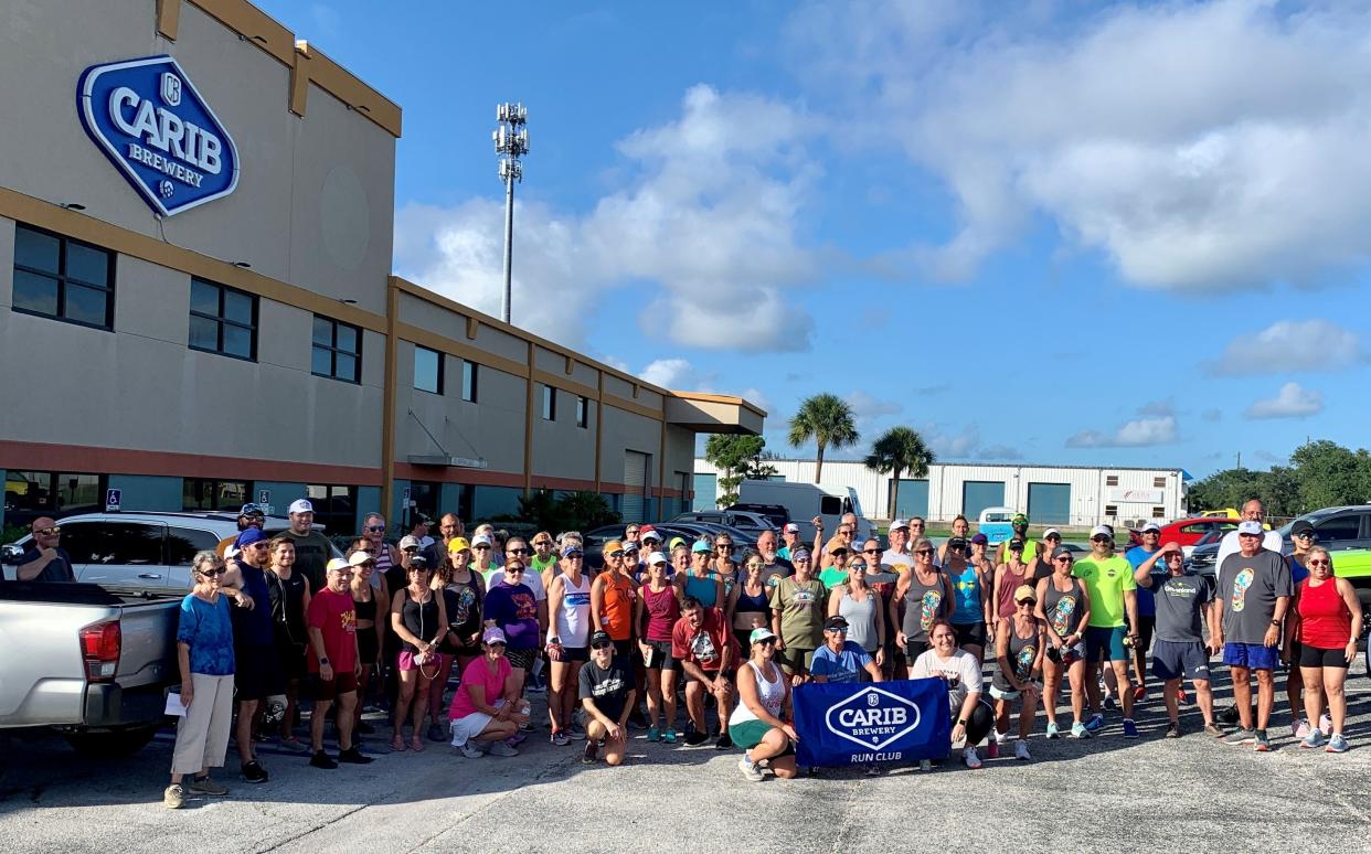 Runners and walkers pause for a photo before the Summer 2022 Brewery Running Tour stop at Carib Brewery in Cape Canaveral.