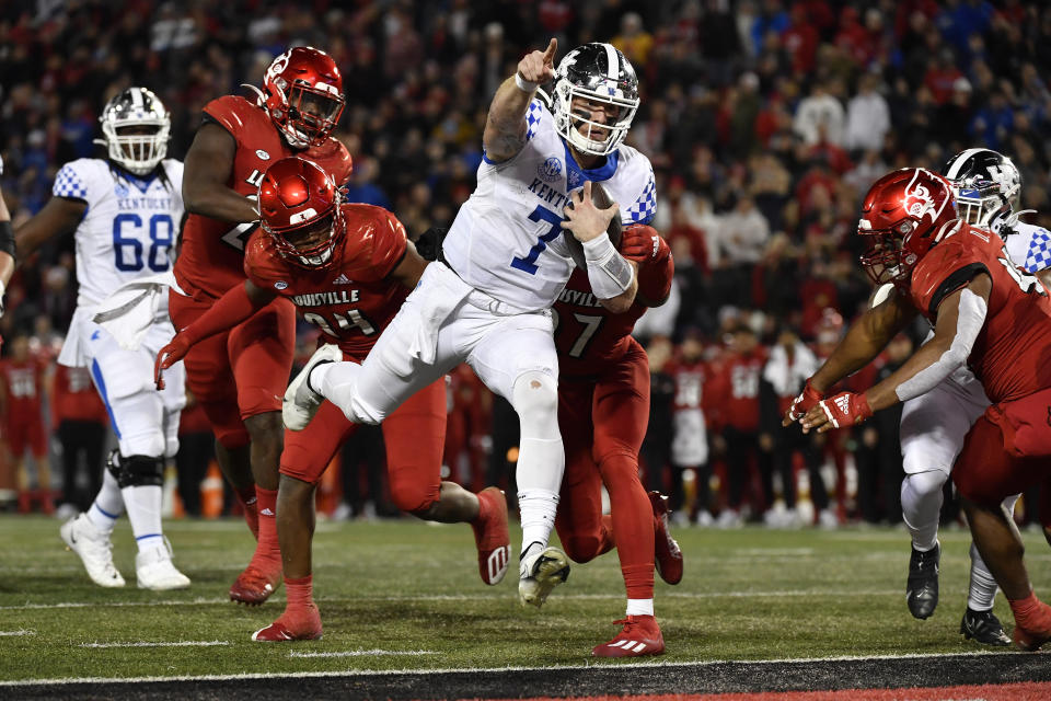 Kentucky quarterback Will Levis (7) signals to the crowd as he crosses the goal line during the first half of an NCAA college football game against Louisville in Louisville, Ky., Saturday, Nov. 27, 2021. (AP Photo/Timothy D. Easley)