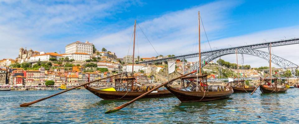 Porto and old  traditional boats with wine barrels in Portugal in a summer day