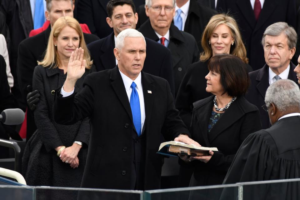 Vice President-elect Mike Pence takes the oath of office next to his wife Karen Pence during the 2017 Presidential Inauguration at the U.S. Capitol.