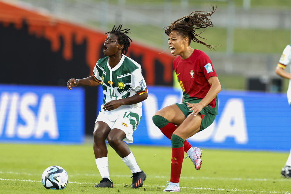 Monique Ngock, left, of Cameroon and Jessica Da Silva of Portugal react as they battle for the ball during their FIFA women's World Cup qualifier in Hamilton, New Zealand, Wednesday, Feb. 22, 2023. (Martin Hunter/Photosport via AP)