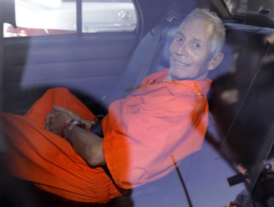 FILE - In March 17, 2015, file photo, New York real estate heir Robert Durst smiles as he is transported from Orleans Parish Criminal District Court to the Orleans Parish Prison after his arraignment on murder charges in New Orleans. Durst's close friend Nathan Chavin said Friday, Feb. 17, 2017, that it took seven months for him to come clean and tell prosecutors what the real estate heir said about killing their close friend. Chavin said he struggled during that time to balance his loyalties to two best friends before deciding to tell "the whole truth" about what he knew about Susan Berman's death. (AP Photo/Gerald Herbert, File)