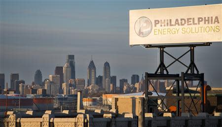 The Philadelphia Energy Solutions oil refinery owned by The Carlyle Group is seen at sunset in front of the Philadelphia skyline March 24, 2014. REUTERS/David M. Parrott