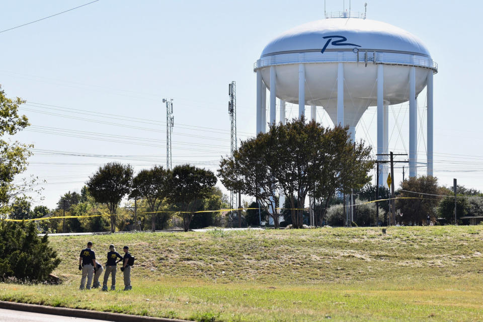 FBI investigators search a grassy area near a ditch where a child's body was found, as the search continued for a missing girl in Richardson, Texas, on Oct. 22, 2017.