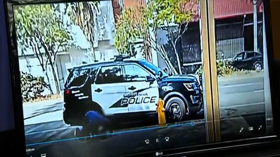 A homeless man crouches on the ground in front of a police vehicle in this surveillance video released by Los Angeles City Council President Paul Krekorian. A portion of this video has been blurred by CNN to protect the person's identity. -  Paul Krekorian/Facebook