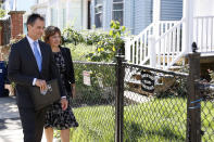 Dan Sideris and his wife, Carrie Sideris, of Newton, Mass., walk along the sidewalk in a neighborhood as they return to door-to-door visits as Jehovah's Witnesses, Thursday, Sept. 1, 2022, in Boston. (AP Photo/Mary Schwalm)