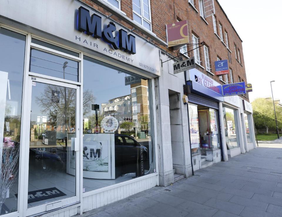 A view of M&M Hair Academy in London, Wednesday, April 16, 2014. Staff at a London hair salon say they had a close shave with North Korean officials after using the country's leader, Kim Jong Un, to promote discount haircuts. M&M Hair Academy says it received a visit by two men from the nearby North Korean embassy after putting up a poster last week featuring a picture of Kim — who sports a distinctive undercut - and the slogan "Bad Hair Day?" (AP Photo/Kirsty Wigglesworth)