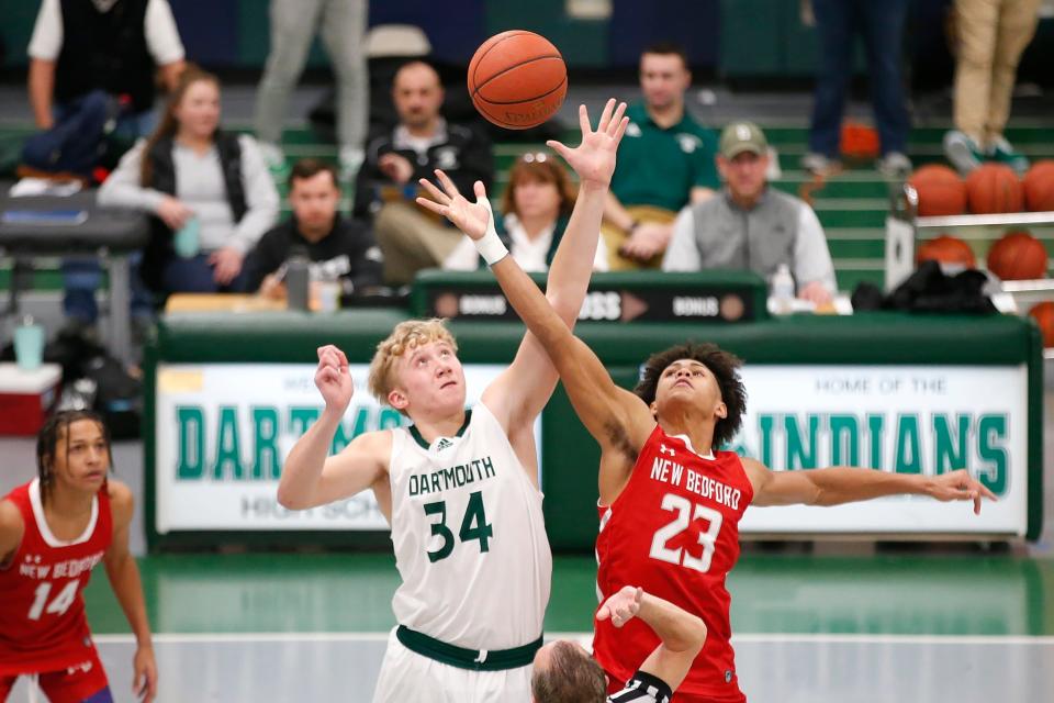 Dartmouth's Hunter Matteson and New Bedford's Anthony Diakite jump for the opening jump ball. Dartmouth High School boys basketball team beat New Bedford High School at home.