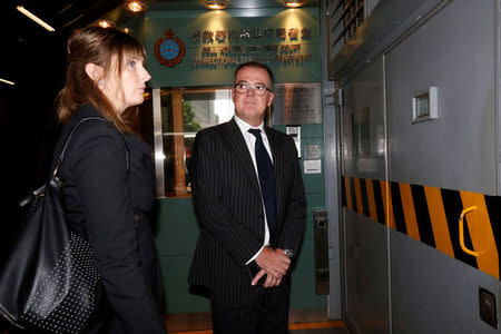 Michael Vidler (R), lawyer of British former banker Rurik Jutting, arrives with an unidentified woman at High Court in Hong Kong, China October 24, 2016. REUTERS/Bobby Yip