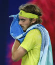 Greece's Stefanos Tsitsipas wipes the sweat from his face during his semifinal against Russia's Daniil Medvedev at the Australian Open tennis championship in Melbourne, Australia, Friday, Feb. 19, 2021.(AP Photo/Andy Brownbill)