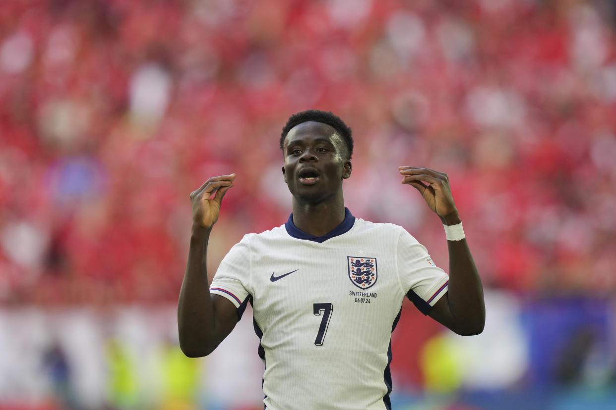 England's Bukayo Saka celebrates scoring his side's first goal during a quarterfinal match between England and Switzerland at the Euro 2024 soccer tournament in Duesseldorf, Germany, Saturday, July 6, 2024. (AP Photo/Martin Meissner)
