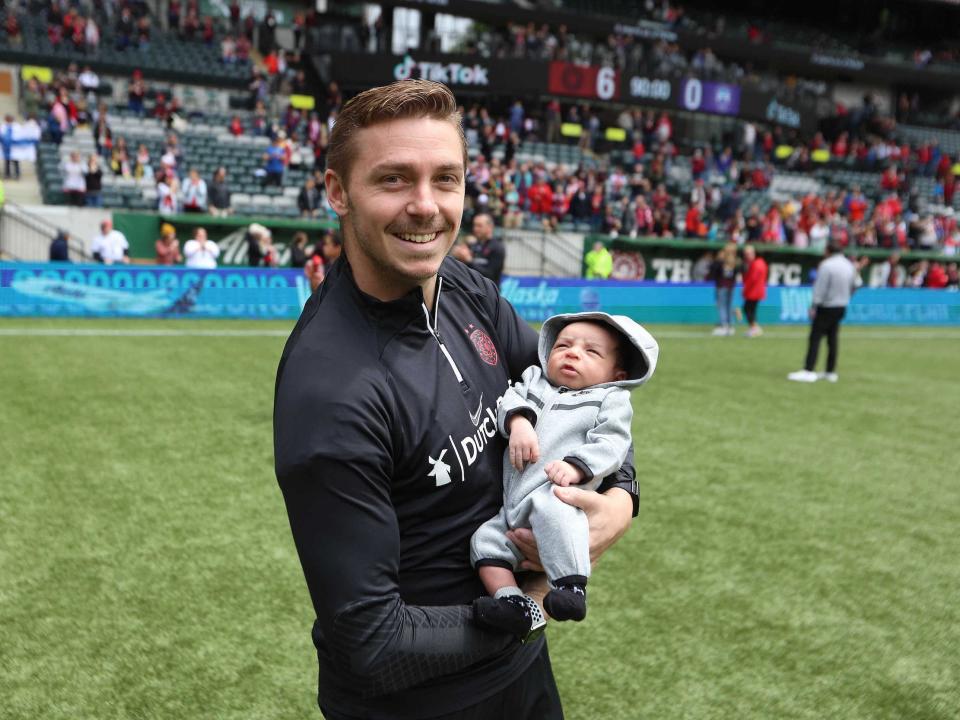 Pierre Soubrier (left) poses with his son at a 2022 NWSL game hosted at Portland's home stadium.